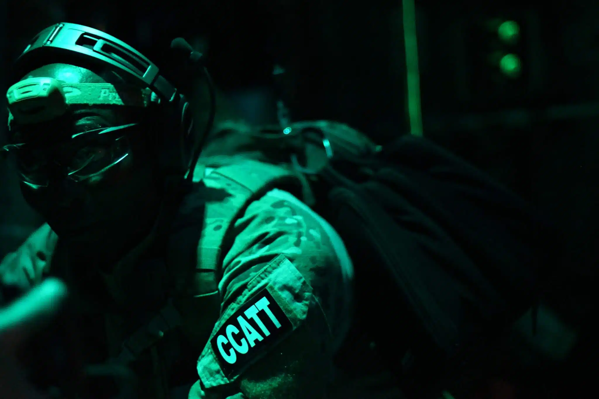 Critical Care Air Transport Team member working in low light