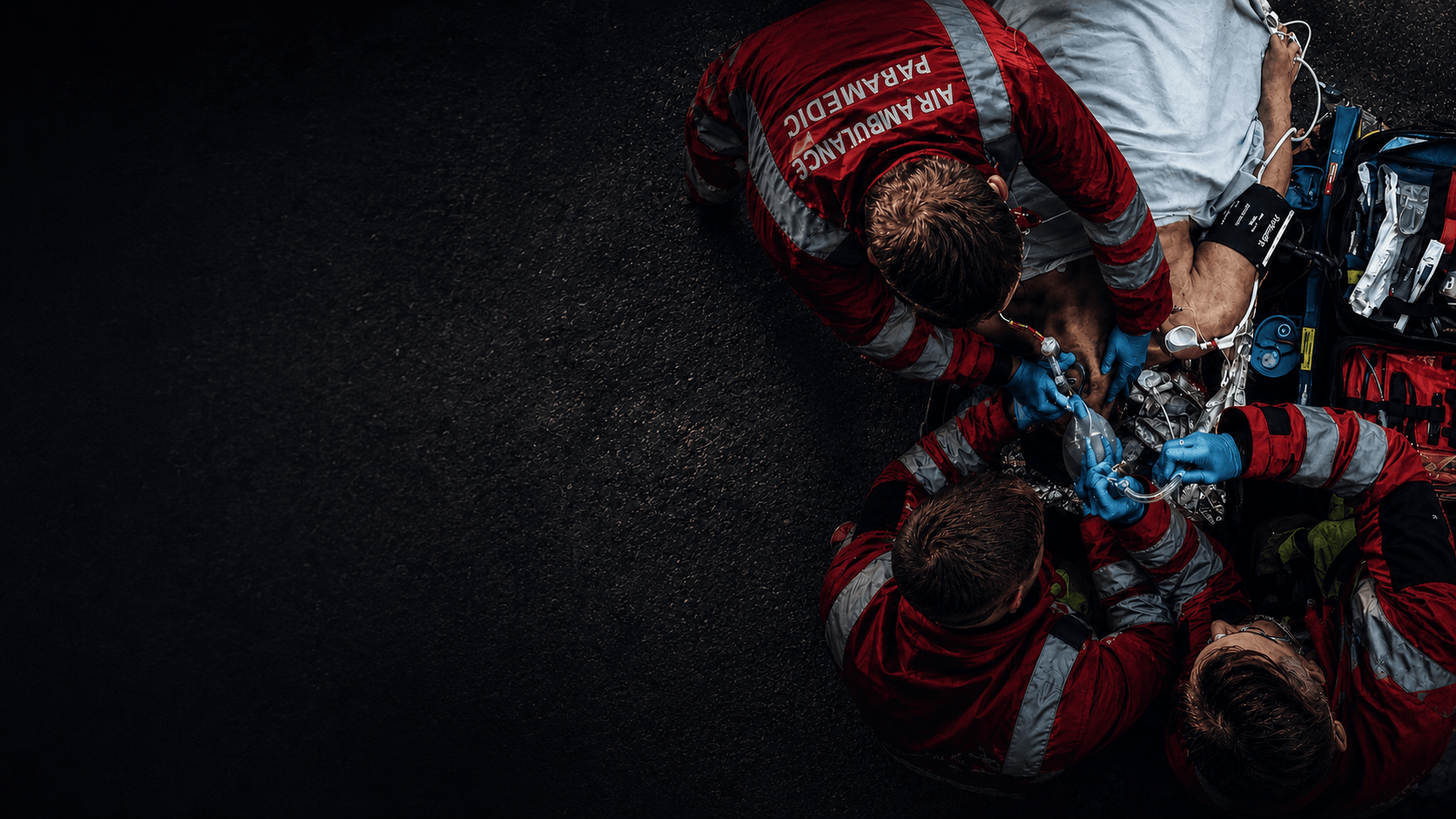 Air ambulance paramedics working around a patient during an airway emergency